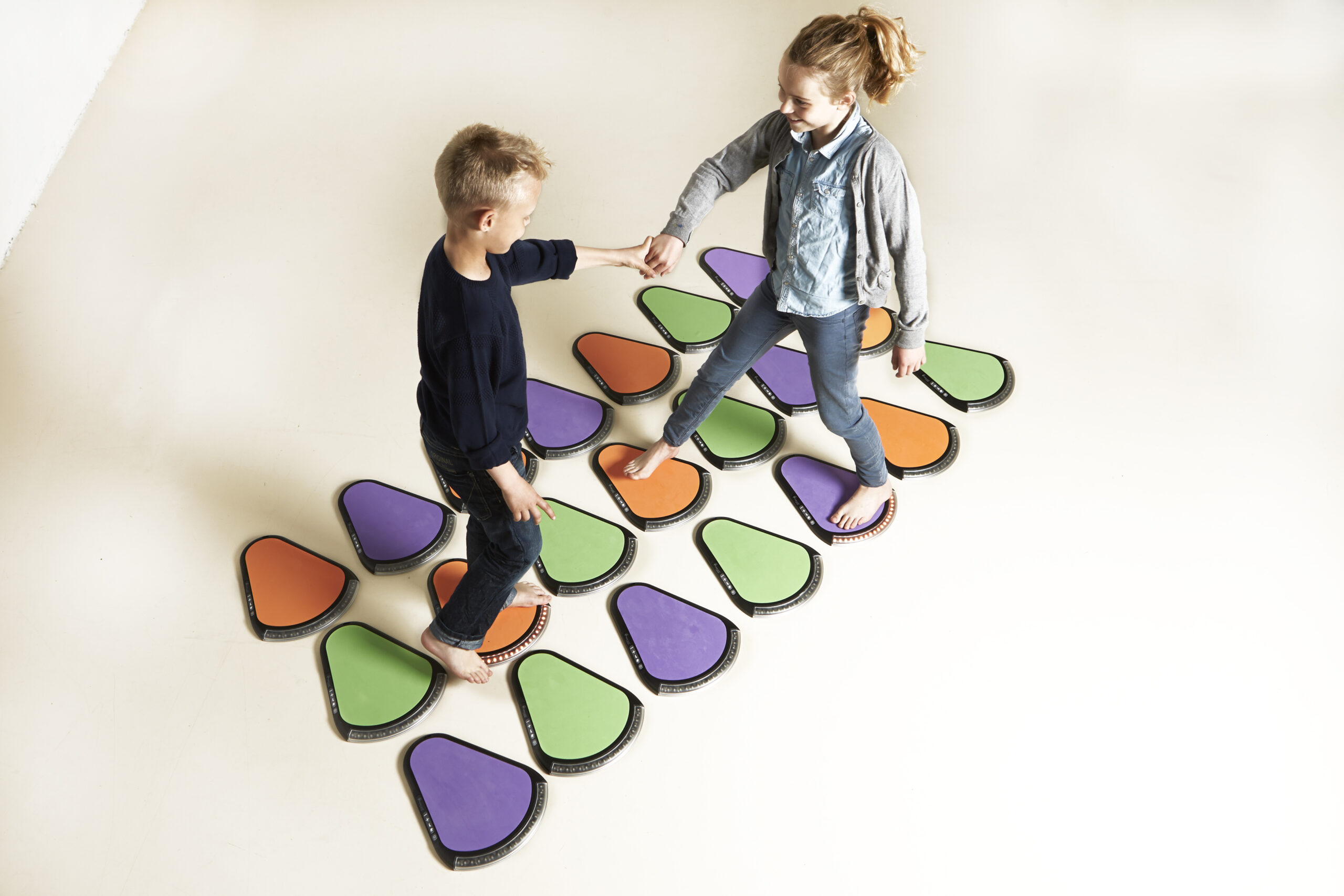 Two children training together on TREAX Pads floor set