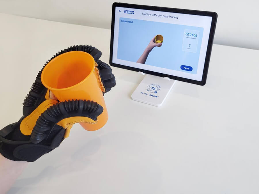 Syrebo C15 robotic glove holding a cup during a task training exercise